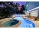 Backyard pool and patio area ideal for entertaining with lounge chairs and a nice outdoor seating area at 322 Ontario Ave, Crystal Beach, FL 34681