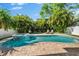 Inviting backyard pool and spa surrounded by lush, tropical landscaping, creating a private oasis at 322 Ontario Ave, Crystal Beach, FL 34681