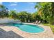 Inviting backyard pool and spa surrounded by lush, tropical landscaping, creating a private oasis at 322 Ontario Ave, Crystal Beach, FL 34681