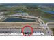 Aerial view of a community featuring interconnected lakes and modern townhome developments at 32573 Turtle Grace Loop, Wesley Chapel, FL 33545
