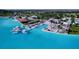 A captivating aerial view of a luxurious community with vibrant blue lagoon, beach club and resort-style amenities at 32573 Turtle Grace Loop, Wesley Chapel, FL 33545