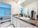 Bathroom features a double sink with granite countertops and plenty of cabinet space at 32573 Turtle Grace Loop, Wesley Chapel, FL 33545