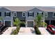 Townhouse exterior with a gray facade and landscaping at 32573 Turtle Grace Loop, Wesley Chapel, FL 33545