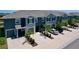 Contemporary townhome exterior with neutral paint, complemented by a driveway, small lawn, and well-maintained landscaping at 32573 Turtle Grace Loop, Wesley Chapel, FL 33545