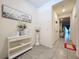 Bright foyer featuring decorative accents and tile flooring leading into the home at 32573 Turtle Grace Loop, Wesley Chapel, FL 33545