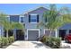 Charming two-story townhome with a well-manicured lawn and a gray exterior at 32573 Turtle Grace Loop, Wesley Chapel, FL 33545