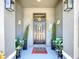 Inviting front porch featuring stylish decorations and potted plants for a welcoming entrance at 32573 Turtle Grace Loop, Wesley Chapel, FL 33545