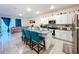 Open concept kitchen with granite island, stainless appliances, and seamless flow to the living area at 32573 Turtle Grace Loop, Wesley Chapel, FL 33545