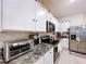 Bright kitchen showcasing granite countertops, stainless steel appliances, and ample cabinet space at 32573 Turtle Grace Loop, Wesley Chapel, FL 33545