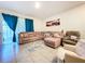 Inviting living room with tile flooring, comfortable seating, and bright natural light at 32573 Turtle Grace Loop, Wesley Chapel, FL 33545