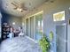 Covered patio featuring tiled floor, ceiling fan with lights, and adjacent yard at 32573 Turtle Grace Loop, Wesley Chapel, FL 33545