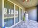 Covered patio with sliding glass doors and views of the backyard at 32573 Turtle Grace Loop, Wesley Chapel, FL 33545