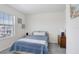Bedroom with window and side table and dresser at 32978 Tulip Petal Ln, Wesley Chapel, FL 33545