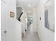 Bright hallway with tile flooring, neutral walls, and staircase leading to the upper level at 32978 Tulip Petal Ln, Wesley Chapel, FL 33545
