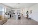 Bright, open-concept kitchen with gray cabinets, stainless steel appliances, and a center island with barstool seating at 32978 Tulip Petal Ln, Wesley Chapel, FL 33545