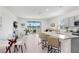 Open-concept kitchen and dining area featuring an island with chairs and views of the backyard at 32978 Tulip Petal Ln, Wesley Chapel, FL 33545