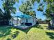 Enjoy this backyard with a deck, privacy fence, and mature trees providing ample shade at 3498 13Th S Ave, St Petersburg, FL 33711