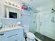 Bright bathroom featuring a glass walk-in shower and white vanity with stone countertop at 3498 13Th S Ave, St Petersburg, FL 33711