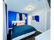 Cozy bedroom with a modern design, featuring a blue accent wall and sleek furniture at 3498 13Th S Ave, St Petersburg, FL 33711