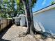 Exterior view of the home's backyard featuring a gravel area, and an old growth tree at 3498 13Th S Ave, St Petersburg, FL 33711