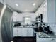 Modern kitchen features stainless steel appliances, granite countertops, and white cabinets at 3498 13Th S Ave, St Petersburg, FL 33711