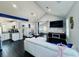 Bright open-concept living room with modern furnishings, dark laminate flooring, and recessed lights at 3498 13Th S Ave, St Petersburg, FL 33711