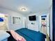 Bright primary bedroom with ensuite access, television, and large mirror at 3498 13Th S Ave, St Petersburg, FL 33711