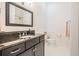 A bathroom featuring a vanity with a dark countertop, an undermount sink, and a framed mirror at 409 Regent N Ln, St Petersburg, FL 33701