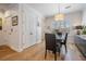 Bright dining area with hardwood floors, modern lighting, and a built-in storage unit at 409 Regent N Ln, St Petersburg, FL 33701
