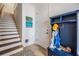 Inviting entryway with staircase, hall tree and storage bench, enhanced by stylish decor and artwork at 409 Regent N Ln, St Petersburg, FL 33701