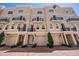 Townhouse complex with garages and beautiful landscaping, including decorative trees and greenery at 409 Regent N Ln, St Petersburg, FL 33701