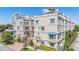 A tan multi-story townhouse complex with beautiful architectural detail and well-maintained landscaping at 409 Regent N Ln, St Petersburg, FL 33701