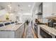 Open kitchen with wooden floors, an island with barstools, stainless appliances, and modern design at 409 Regent N Ln, St Petersburg, FL 33701