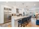 Open kitchen with stainless steel appliances, marble countertops, and adjacent living area at 409 Regent N Ln, St Petersburg, FL 33701