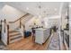 Open concept kitchen with hardwood floors, island seating, and stairs to the second floor at 409 Regent N Ln, St Petersburg, FL 33701