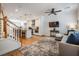 Inviting open-concept living room with modern kitchen, hardwood floors and staircase to upper level at 409 Regent N Ln, St Petersburg, FL 33701