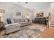 Cozy living room features a plush sofa, bright windows, and a decorative rug on hardwood floors at 409 Regent N Ln, St Petersburg, FL 33701