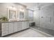 Stunning bathroom boasts double vanity, a large glass-enclosed shower, and elegant gray tile at 409 Regent N Ln, St Petersburg, FL 33701