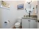 Stylish powder room features modern fixtures, granite countertop, and decorative artwork at 409 Regent N Ln, St Petersburg, FL 33701