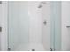 Modern bathroom with white tiled walk-in shower featuring glass doors and sleek fixtures at 409 Regent N Ln, St Petersburg, FL 33701