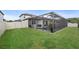 Manicured lawn and fenced backyard with a screened-in pool and patio, perfect for entertaining at 4108 Mellon Dr, Odessa, FL 33556