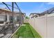 Narrow fenced backyard with a screened-in patio, seating area, and view of the pool at 4108 Mellon Dr, Odessa, FL 33556