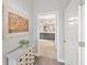Hallway view of bathroom with double sinks, decorative mirror, and under cabinet storage at 4108 Mellon Dr, Odessa, FL 33556