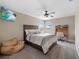 Bedroom with a full bed, window, ceiling fan, television, desk, and sitting chair at 4108 Mellon Dr, Odessa, FL 33556