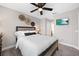 Bedroom with a queen bed, window, ceiling fan, and wall decorations at 4108 Mellon Dr, Odessa, FL 33556