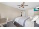 Comfortable bedroom featuring a ceiling fan, television, and doorway to the en suite at 4108 Mellon Dr, Odessa, FL 33556