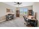 Office/bedroom featuring two desks, comfortable office chairs, and natural light at 4108 Mellon Dr, Odessa, FL 33556