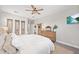 Bright bedroom with neutral tones, decorative accents, ceiling fan, and natural wood dresser at 4108 Mellon Dr, Odessa, FL 33556