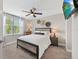 Bedroom with a queen bed, window, ceiling fan, and television at 4108 Mellon Dr, Odessa, FL 33556