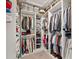 Walk-in closet with custom shelving, ample storage, and organized hanging space for clothing and accessories at 4108 Mellon Dr, Odessa, FL 33556